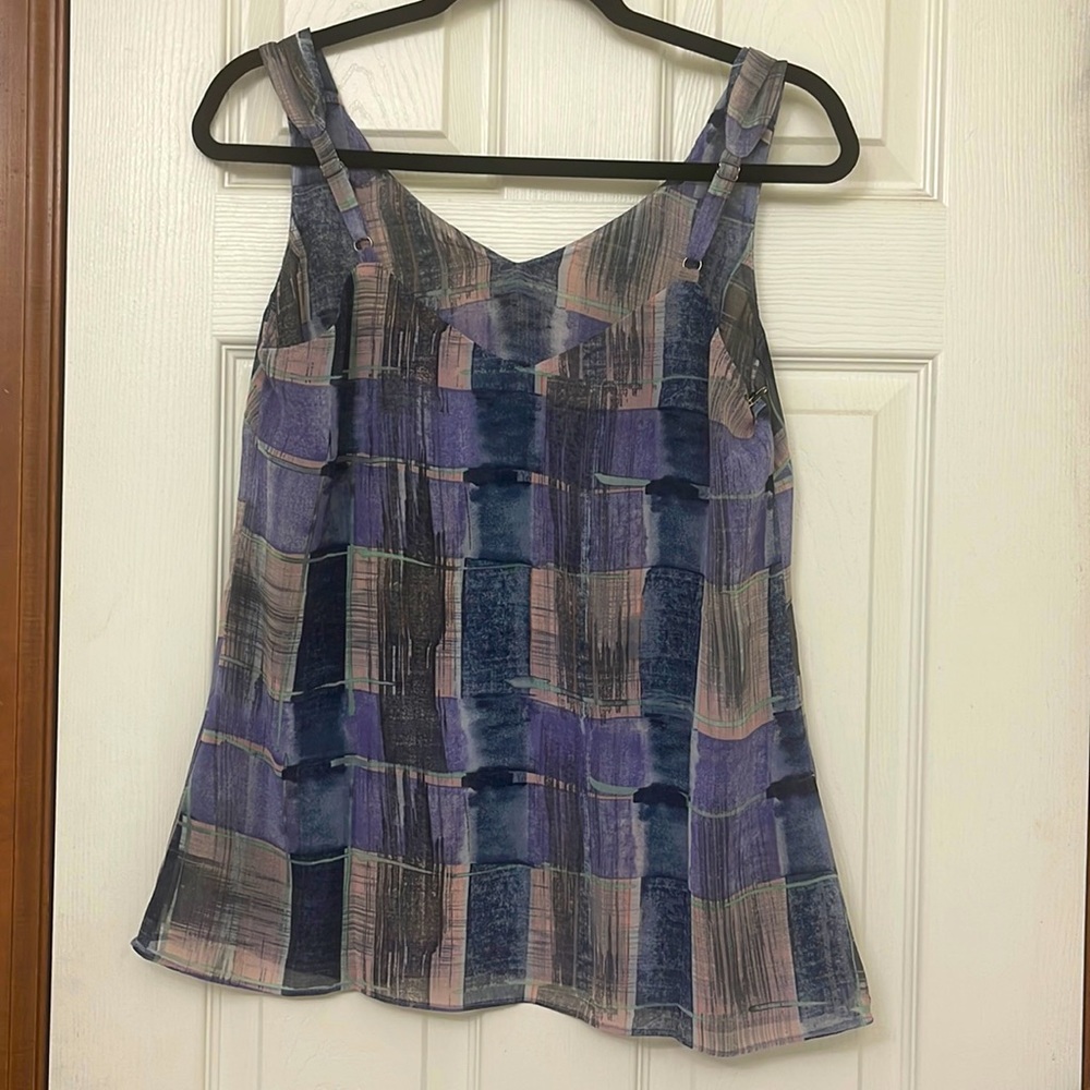 This Quiz Top which is painted Plaid is 100% Polyester.